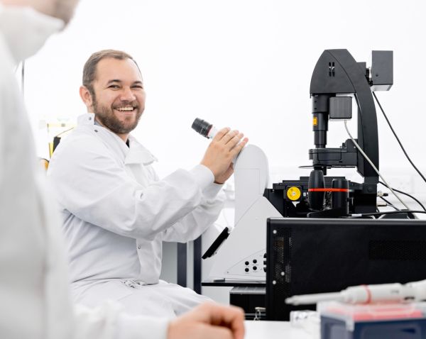 A scientist using a microscope.